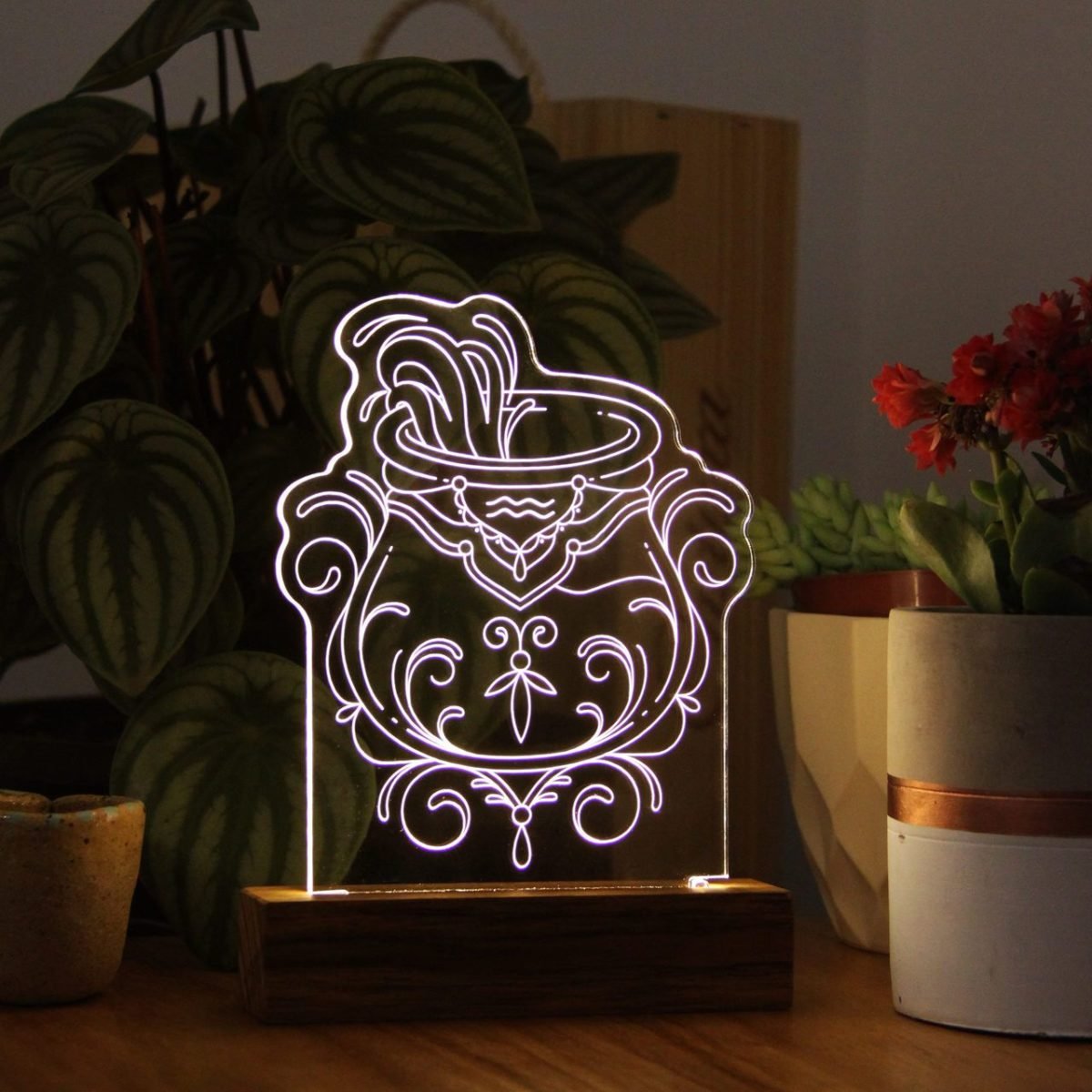 luminária acesa com o símbolo do signo de aquário